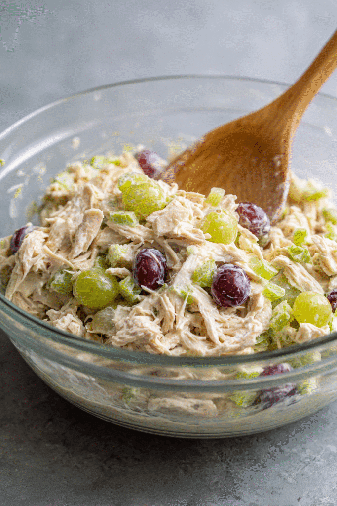 mixing 5 ingredient chicken salad recipe in glass bowl